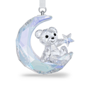 A faceted crystal teddy bear ornament sitting on a crescent moon and holding a star, suspended by a white ribbon with a silver loop, shown on a clean white background.