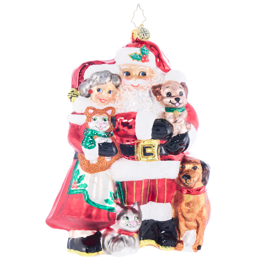 A decorative holiday ornament featuring Santa Claus and Mrs. Claus with multiple pets, including cats and dogs, in a festive Christmas outfit.
