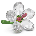 A Swarovski crystal figurine of a hibiscus flower with clear petals, a green metal stem, and a pink metal pistil.