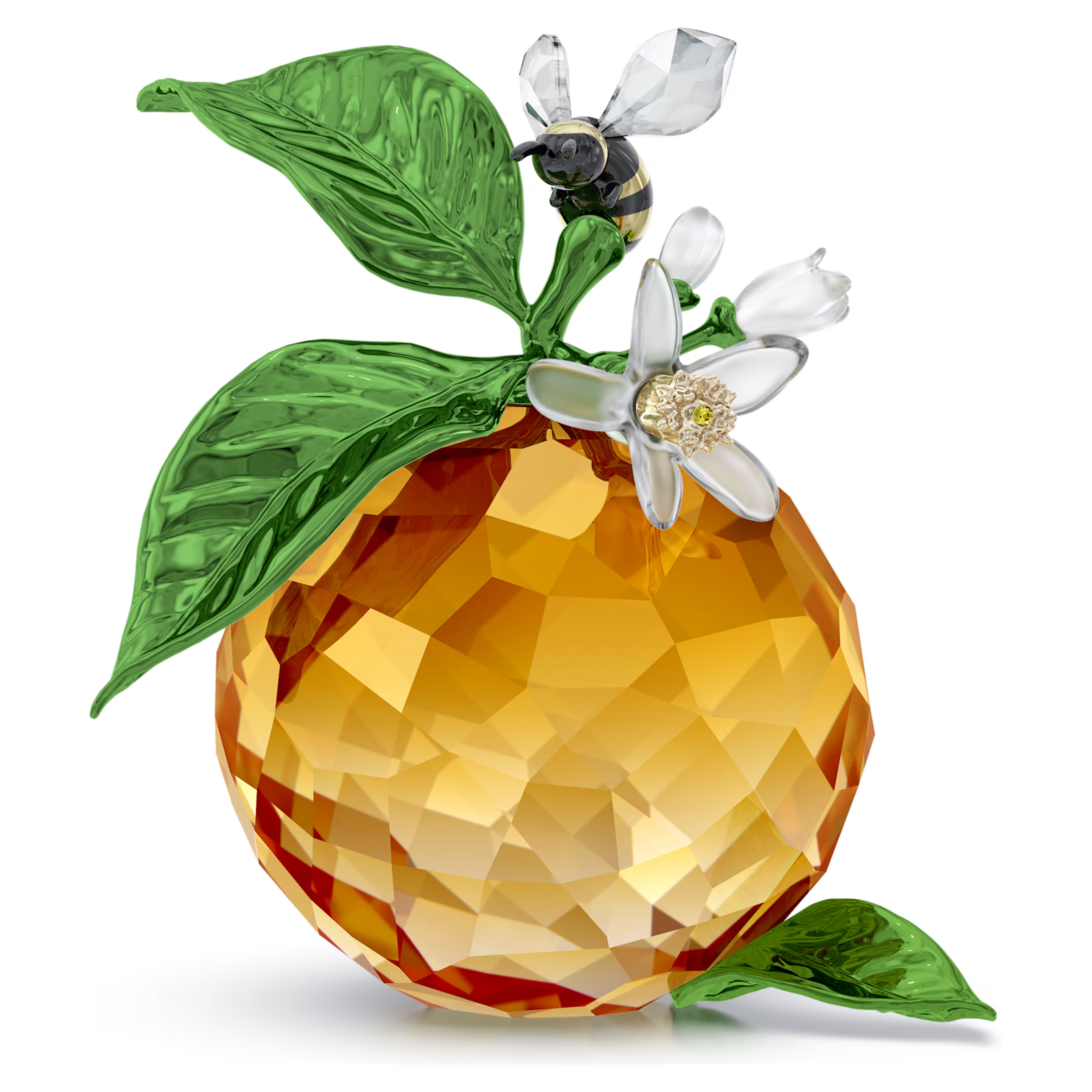 A crystal figurine of a clementine with a matte-finished blossom and a glossy metal bee on top, all in multicolored tones.