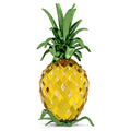 A crystal pineapple decoration with yellow body and green lacquered metal leaves.
